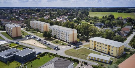 Das Bild zeigt aus der Vogelperspektive eine Wohnsiedlung mit Hochhäusern, Geschosswohnungsbauten und Einfamilienhäusern.