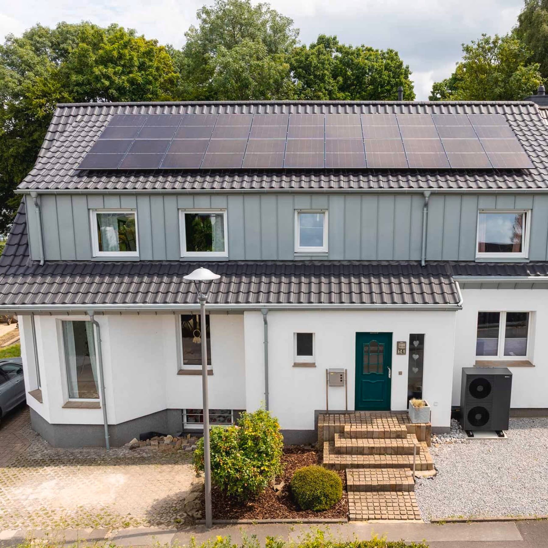 Außenansicht des Hauses mit einer schwarzgrauen Vaillant Wärmepumpe