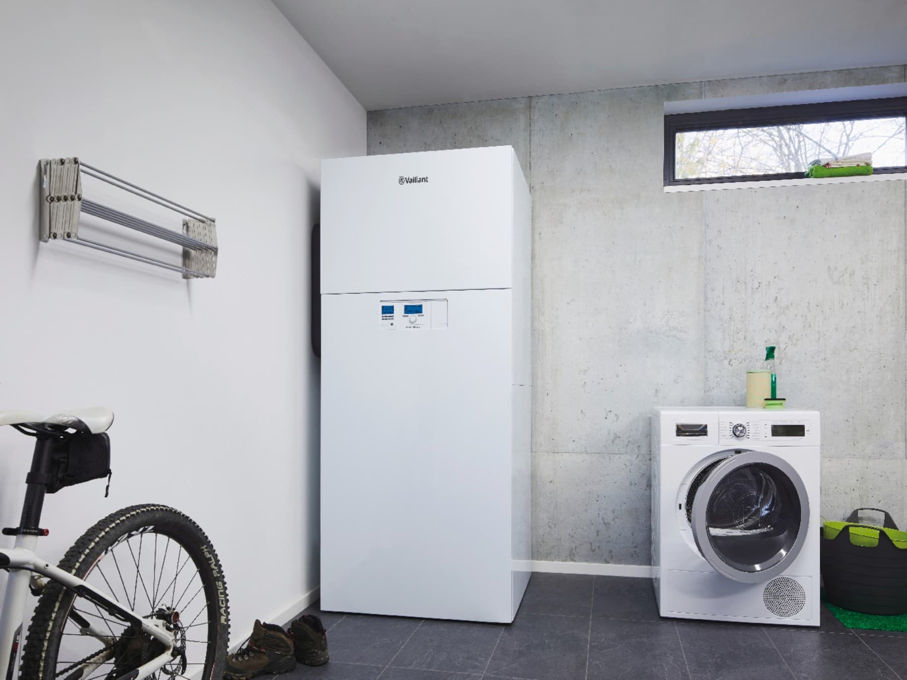 Das versoTHERM plus Gerät steht in einem Kellerraum neben einer Waschmaschine.