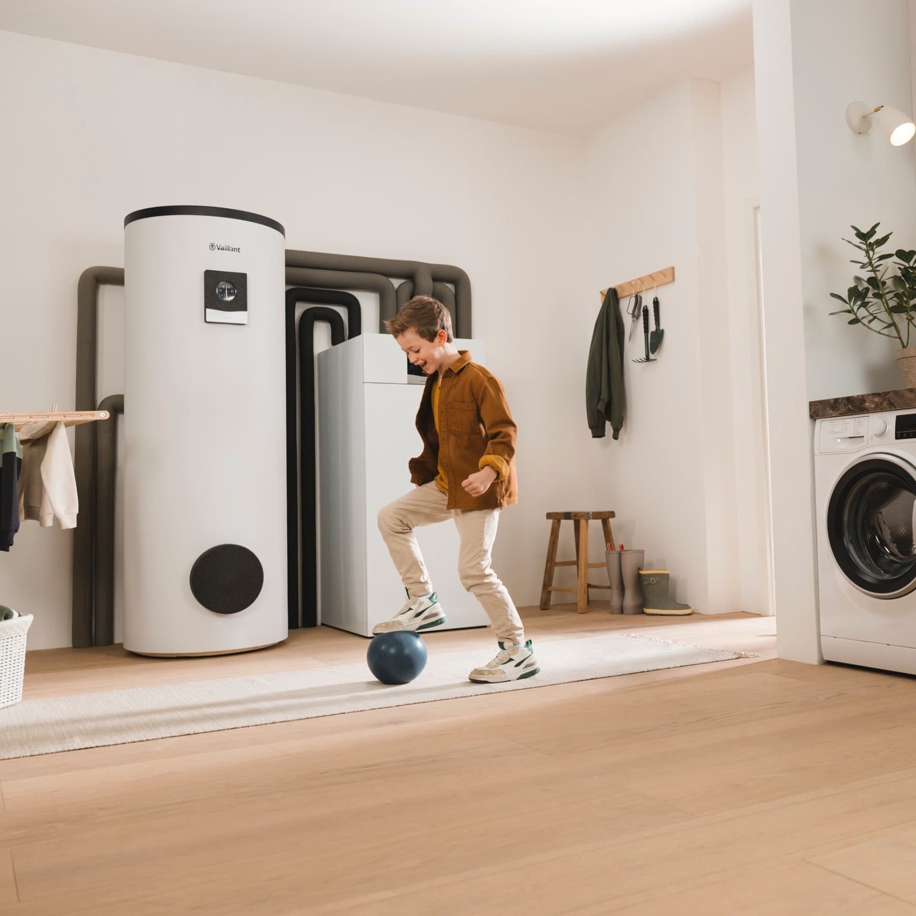Woman in kitchen in front of boiler