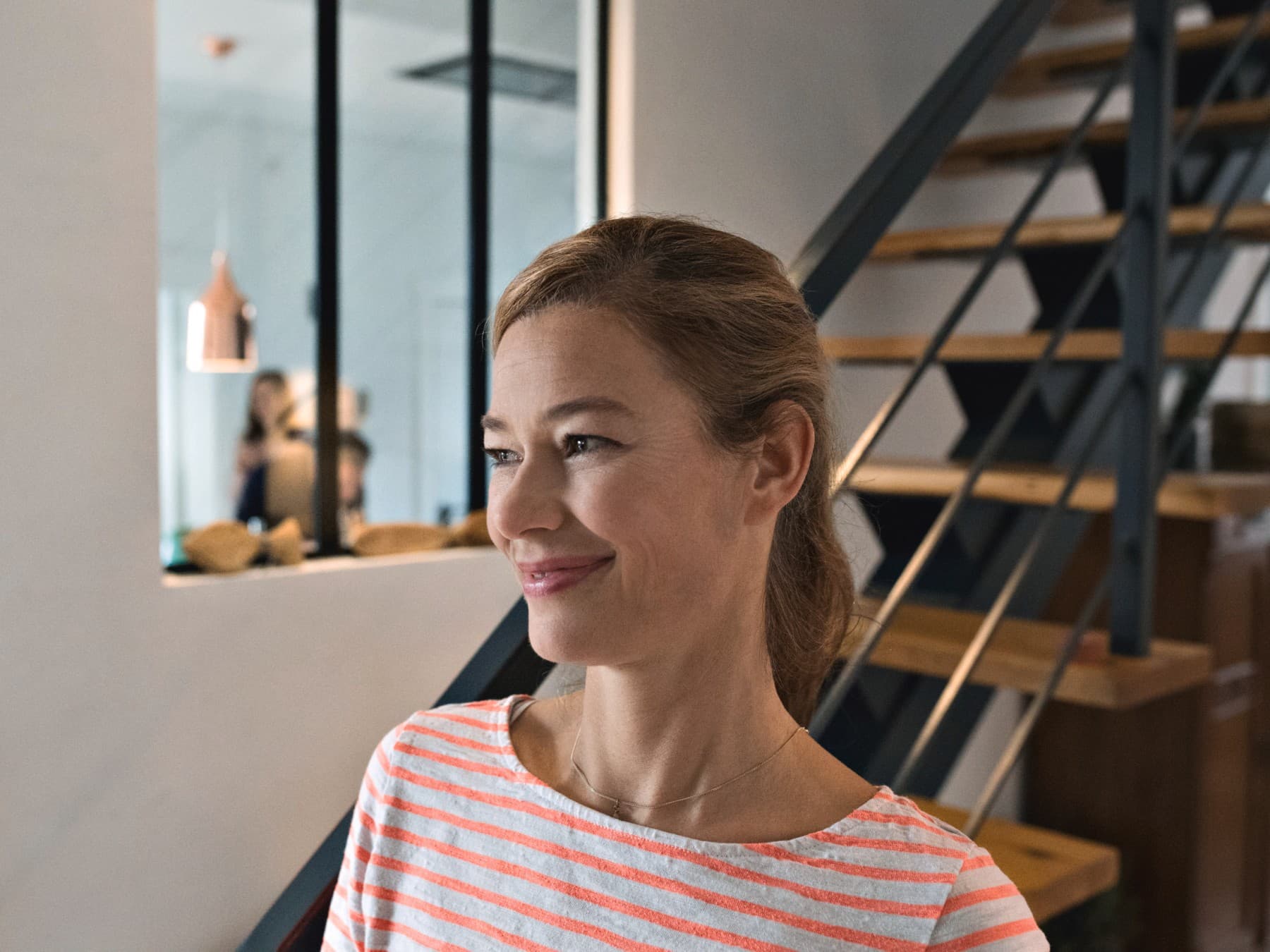 Lächelnde Frau vor einer Wand
