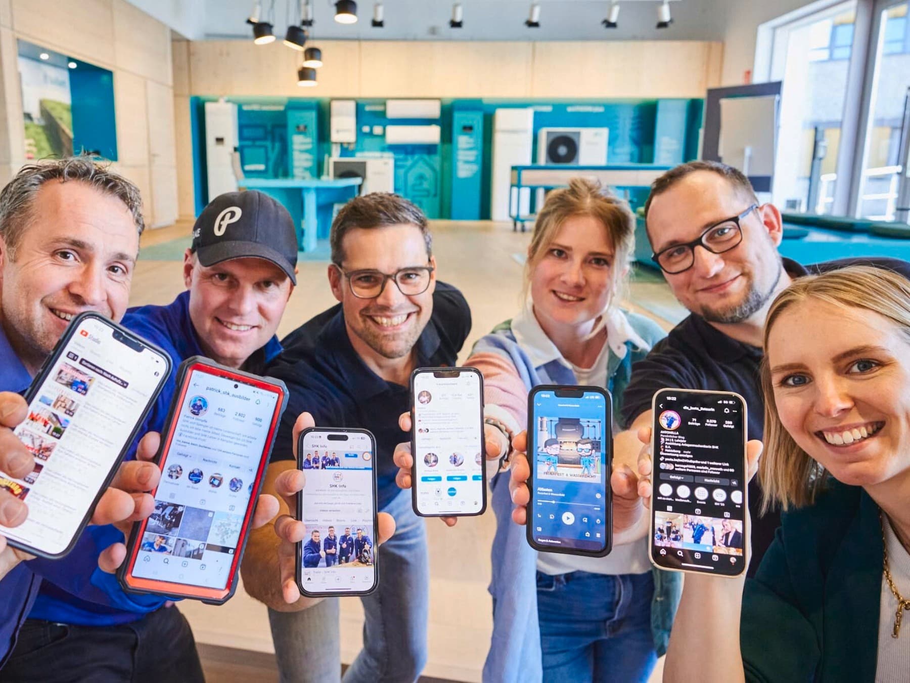 Influencerinnen und Influencer, die ihr Handy in die Kamera halten